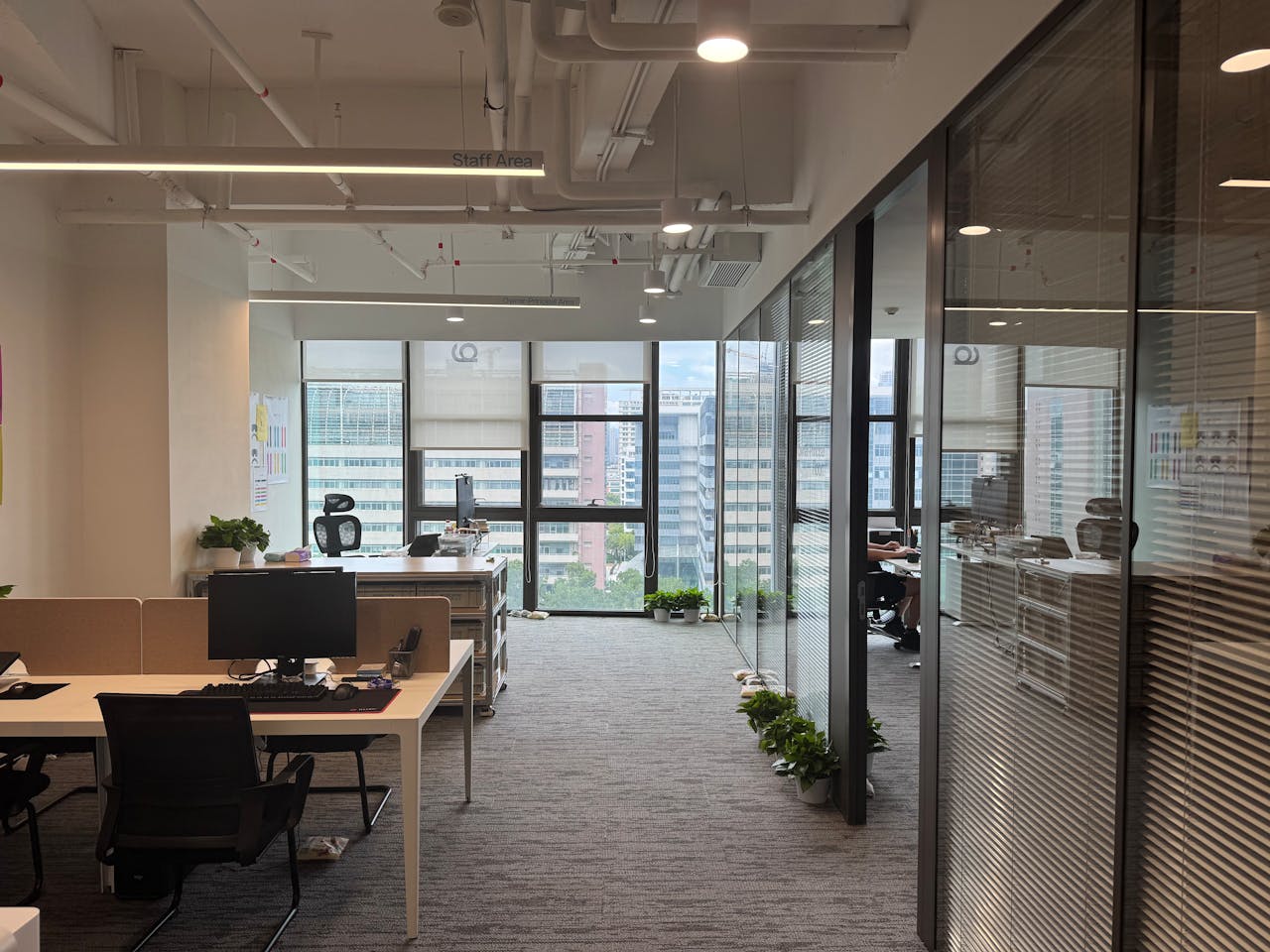 Services Bright, modern office interior with large windows and open workspace design.