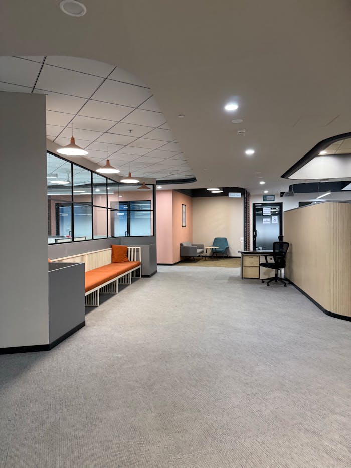 Services Spacious office interior with modern furnishings and neutral tones.